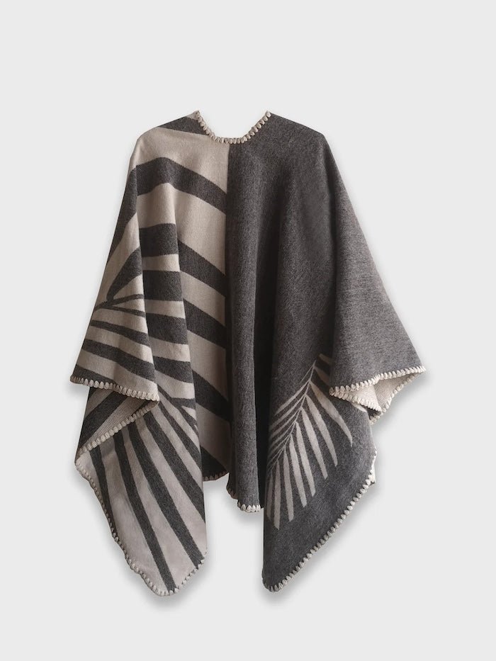 Back of grey Natura Poncho on a white background. This poncho features a color block design with leaflike pattern on the darker half. On the lighter half is ti just a small rectangle box of a leaf.