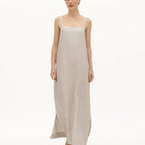 Image of a woman wearing a long dress with pockets and spaghetti straps that was made in Colombia by NAOS. The purpose of this image is to highlight the dress, which is for sale at EVAMAIA boutique in Studio City, CA and online.