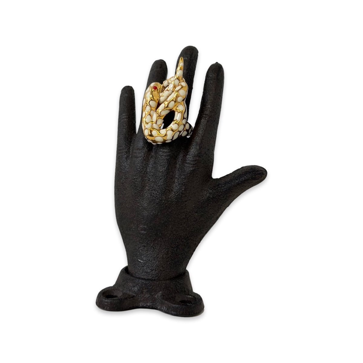 White "Serpiente" Snake Ring on a black hand sculpture on white background