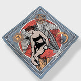 Zodiac Scarf for Virgo made by Plissé. Image of maiden with angel wings. She is on top of a red astrological background. Details of an ecliptic, sun, moon, and mountain range. The scarf is a soft greyish blue color floating on top of a plain white background.
