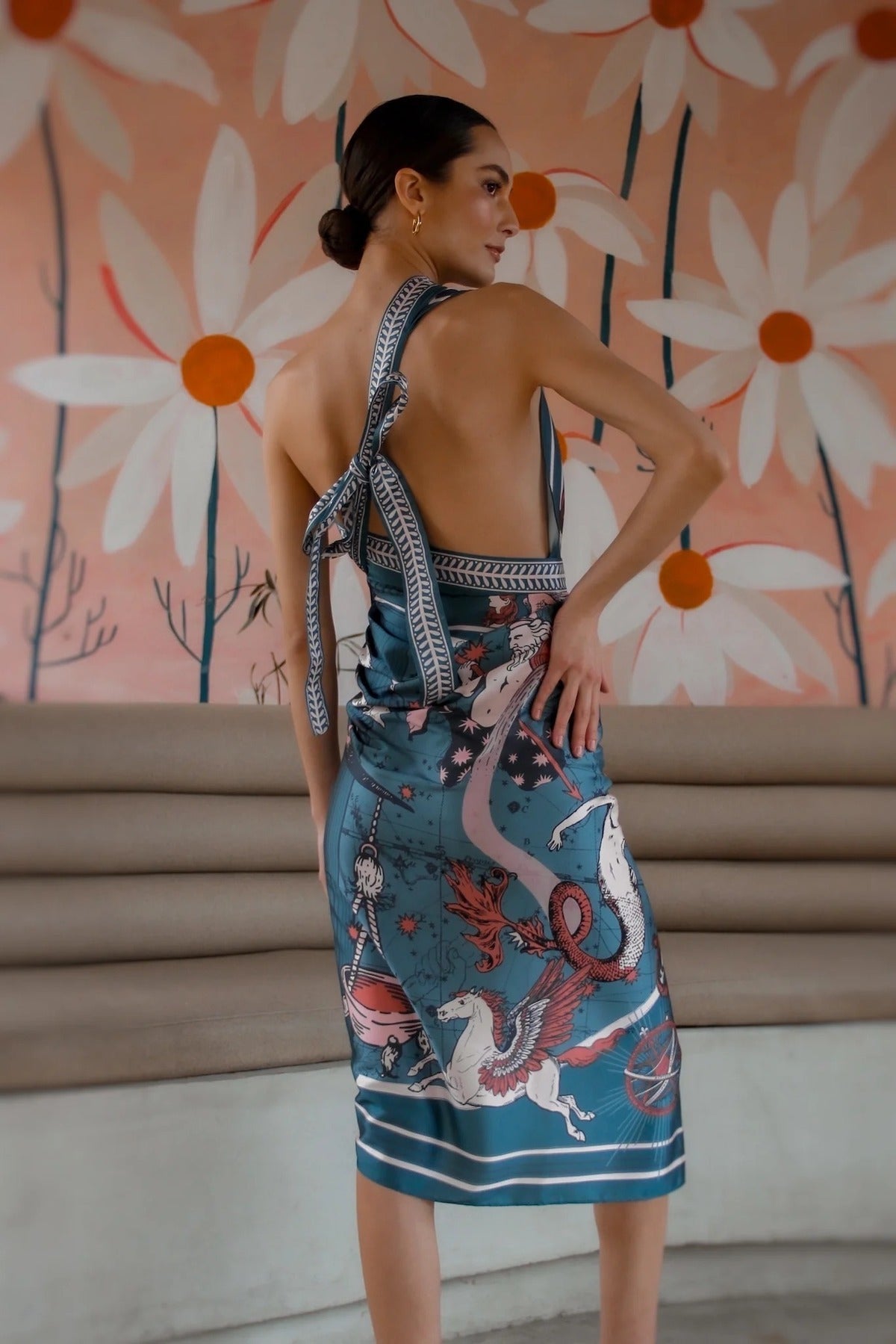 Model posing in Air Zodiac Wrap Dress with arm on hip