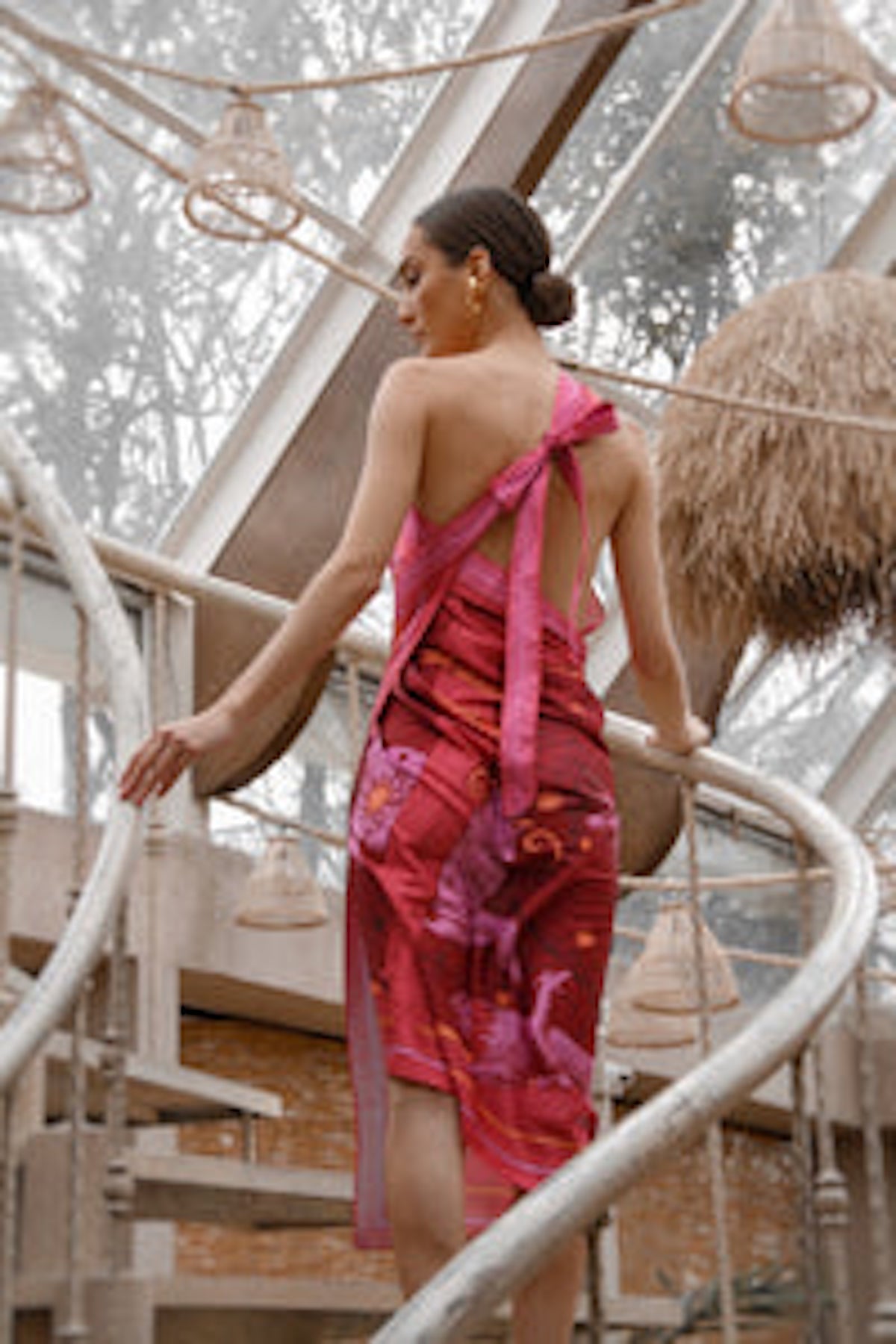 Back of Woman modeling Fire Zodiac Wrap Dress standing on stairs