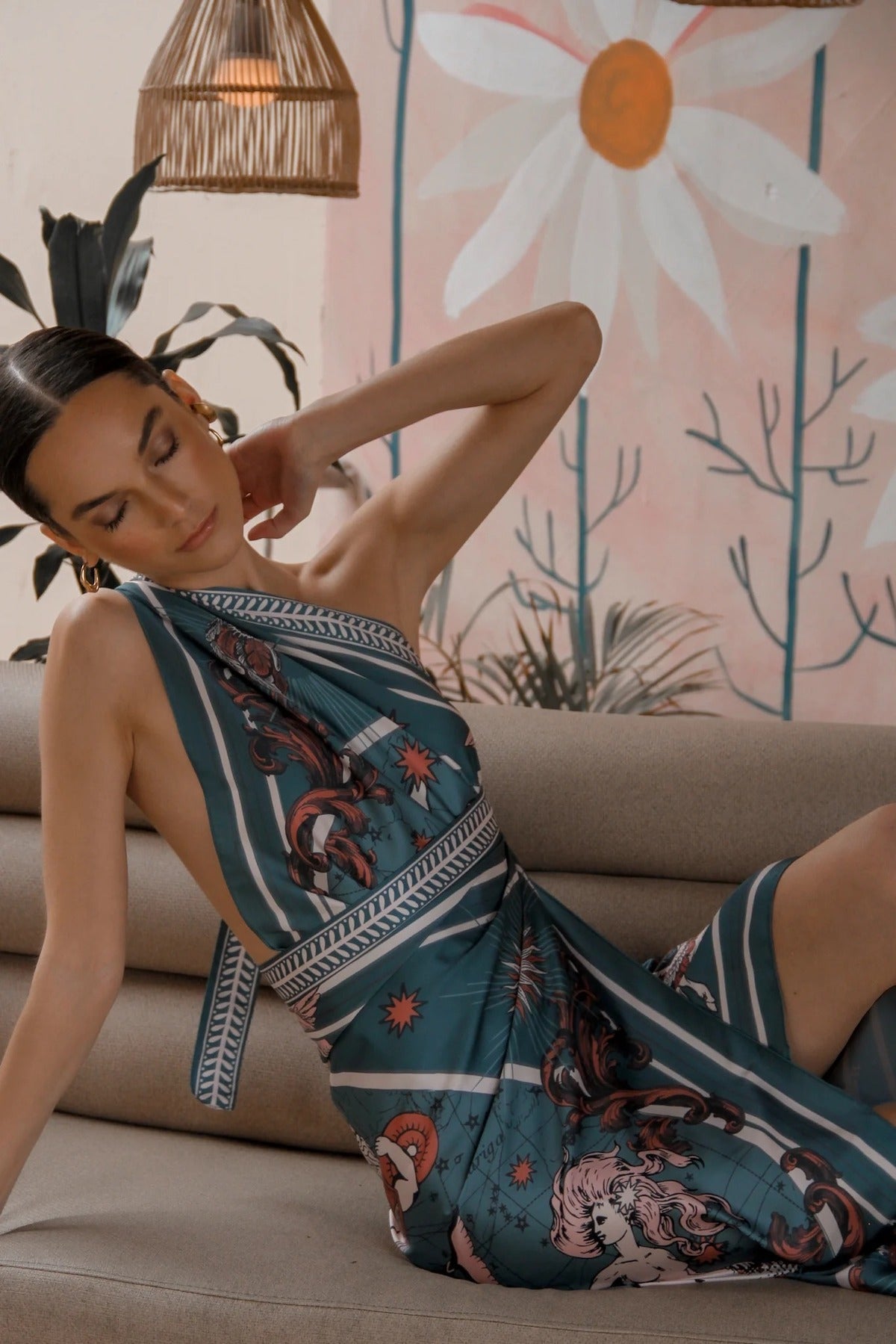 Woman modeling Air Zodiac Wrap Dress laying on couch
