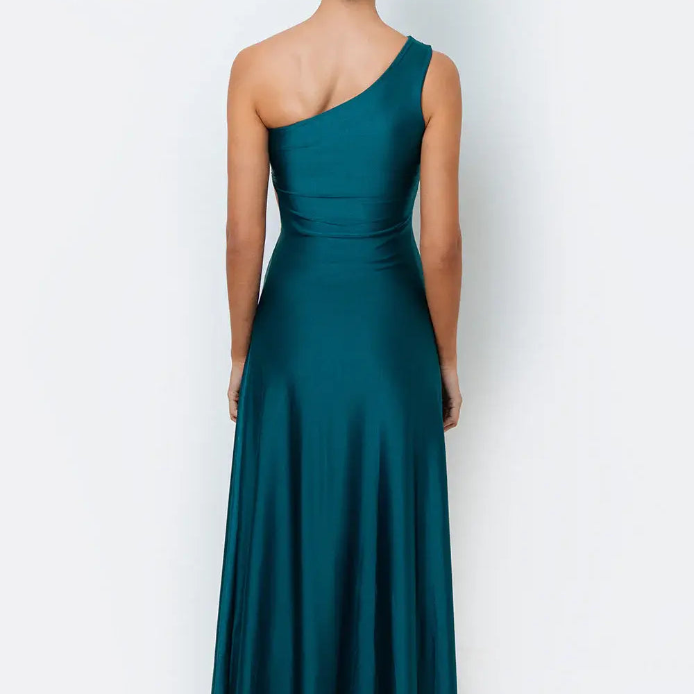 A model wearing wearing an emerald green maxi dress with a one-shoulder design and a side cutout.