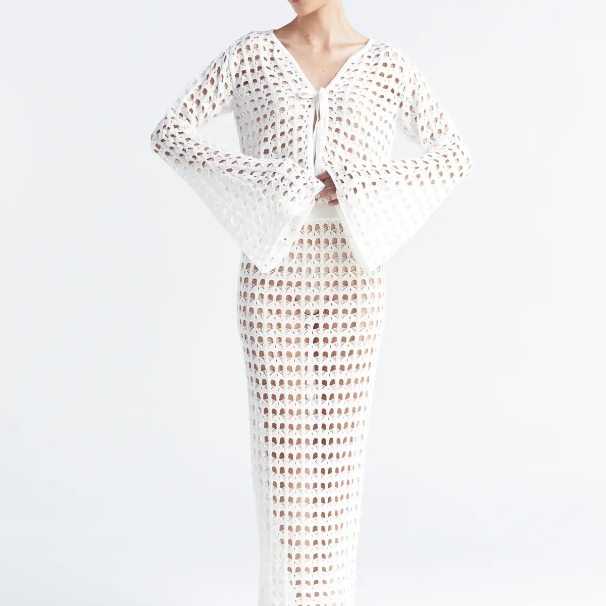 Matching white crochet top and skirt on a white background.