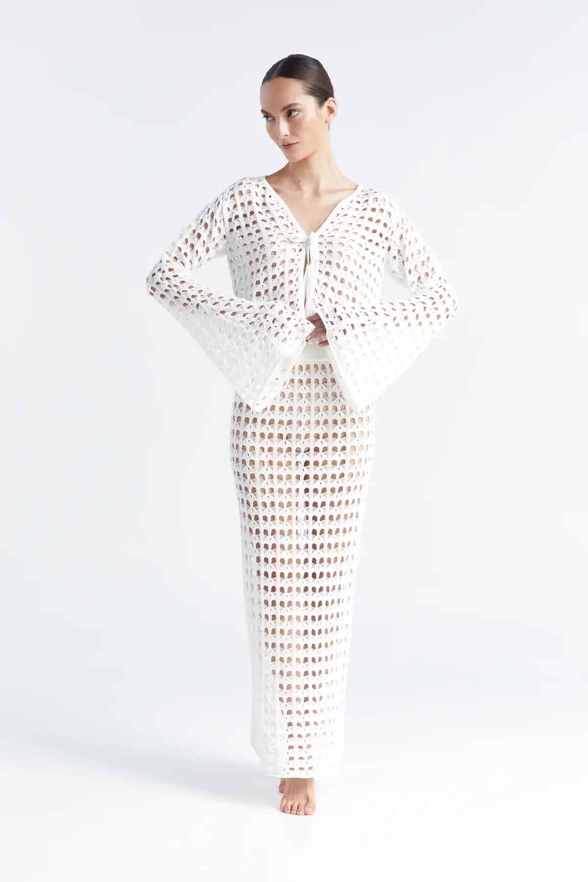 Matching white crochet top and skirt on a white background.