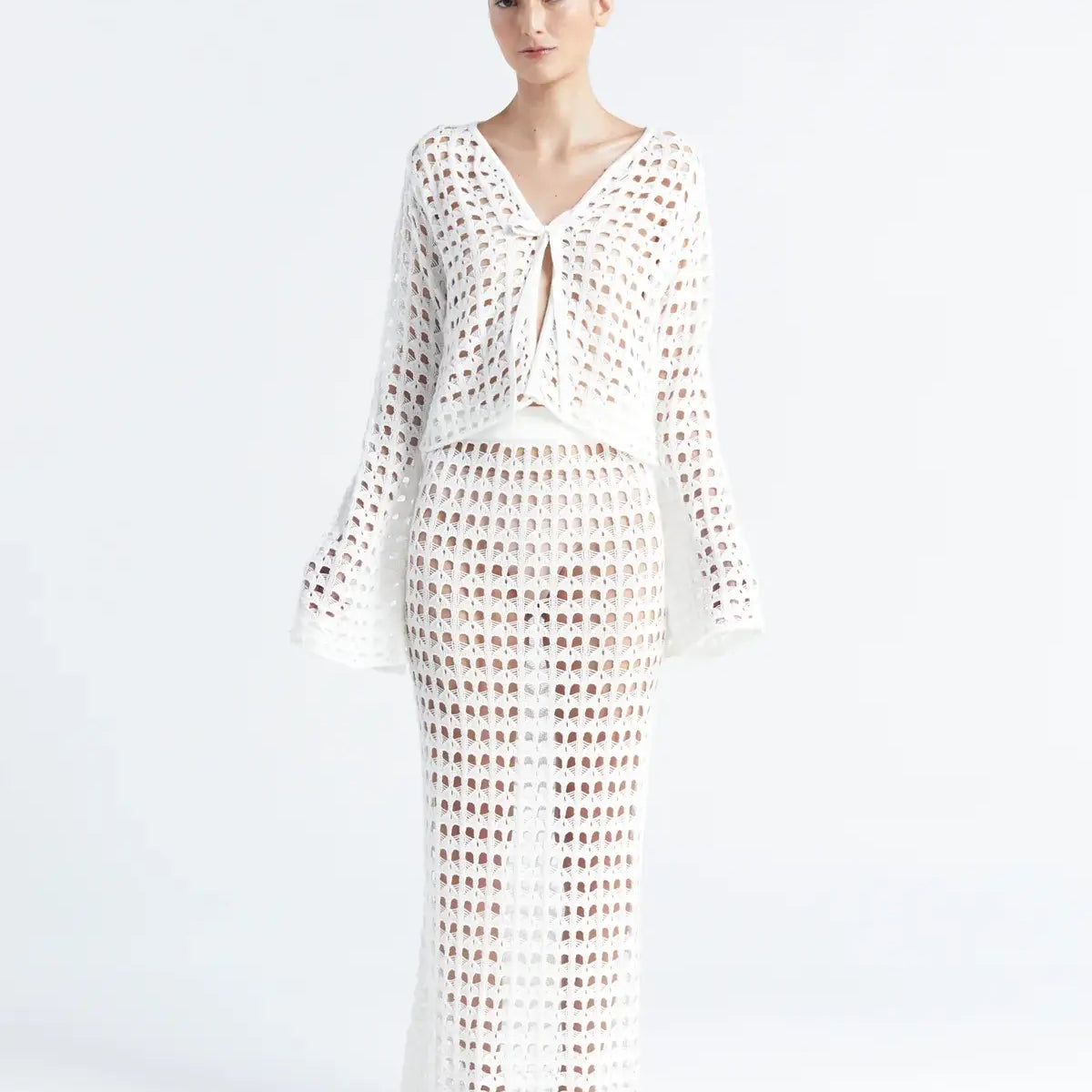 Matching white crochet top and skirt on a white background.