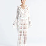 Matching white crochet top and skirt on a white background.