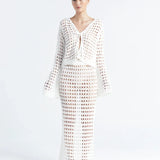 Matching white crochet top and skirt on a white background.