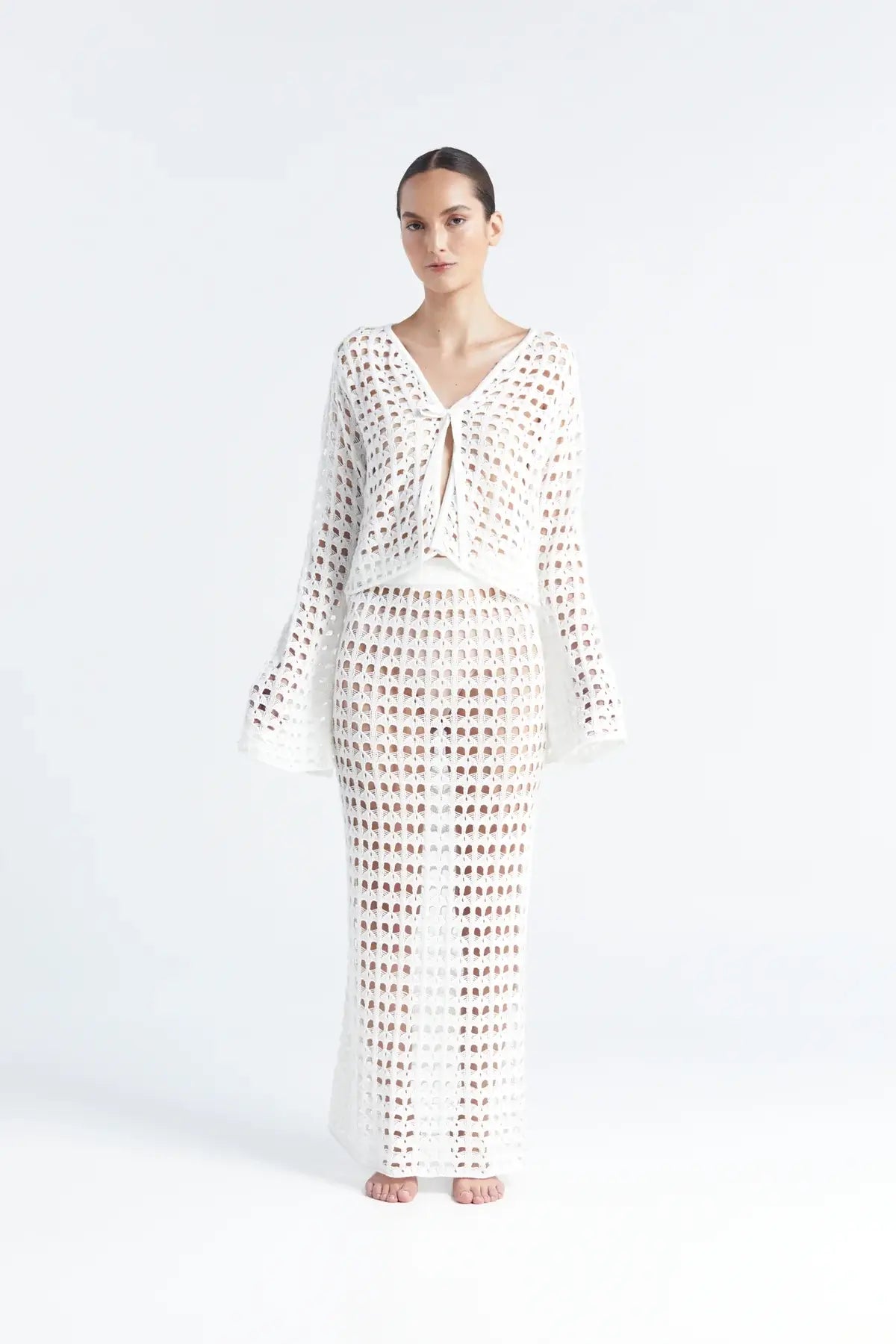 Matching white crochet top and skirt on a white background.