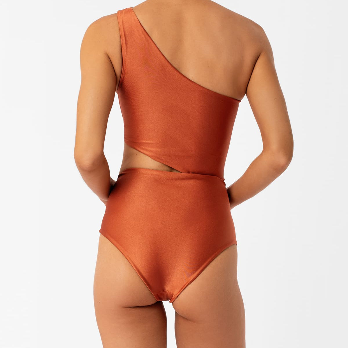 Diana orange one-shoulder one-piece swimsuit by Encantadore with ruching and side cutout, back view. Available at EVAMAIA in Studio City, Los Angeles.