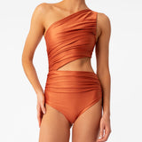 Diana orange one-shoulder one-piece swimsuit by Encantadore with ruching and side cutout. Available at EVAMAIA in Studio City, Los Angeles.