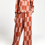 Checkered outfit with a shirt and pants on a white background.