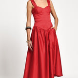 Red dress worn by a woman on a white background.