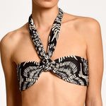 Black and white patterned bikini top on a plain background.