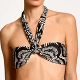 Black and white patterned bikini top on a plain background.
