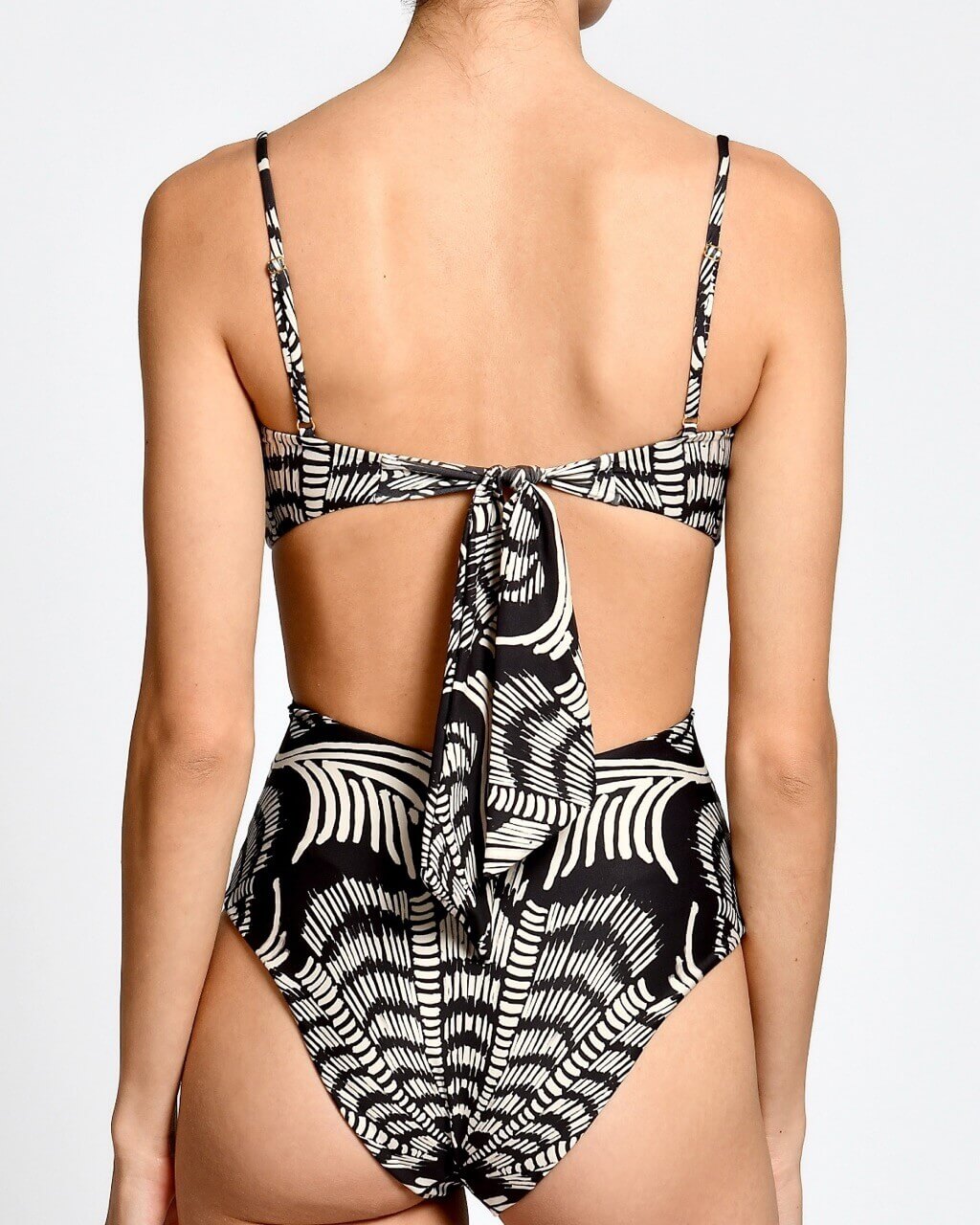Black and white patterned swimsuit on a plain background.