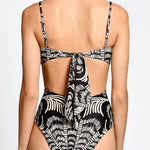 Black and white patterned swimsuit on a plain background.