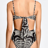 Black and white patterned swimsuit on a plain background.