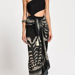 Black one-shoulder bathing with a wrap skirt with black and white patterns. 