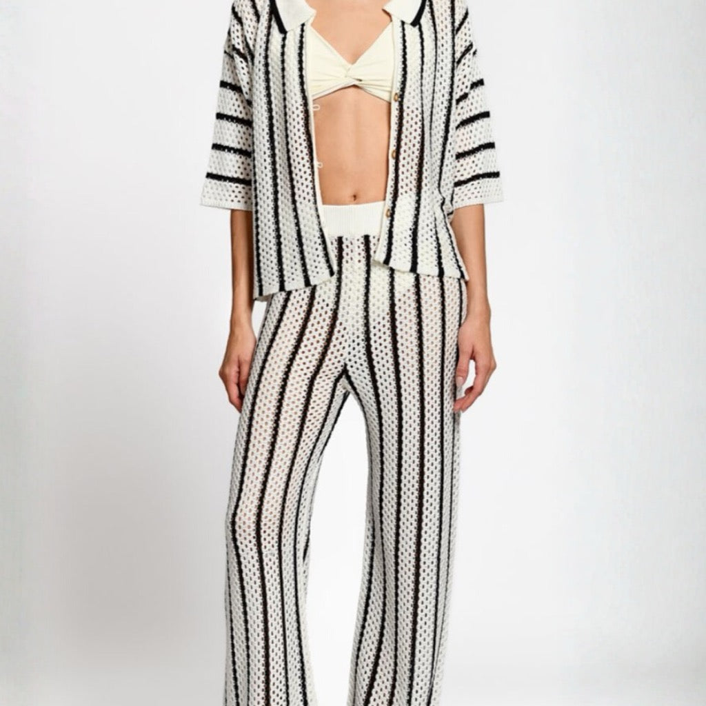 Person wearing a black and white matching set on a white background.