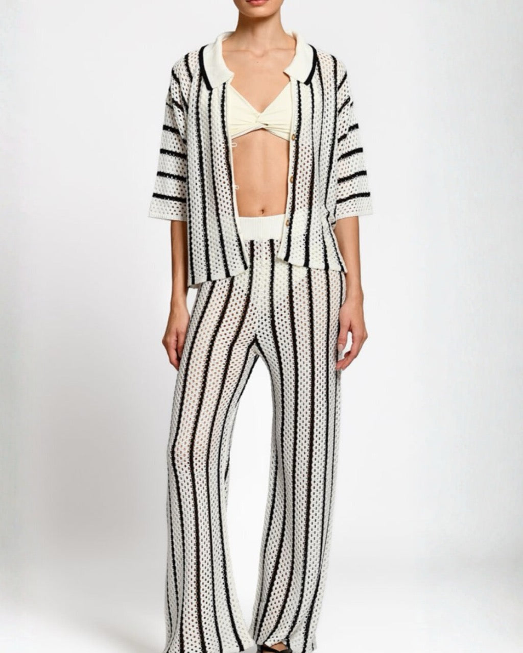 Person wearing a black and white matching set on a white background.