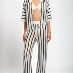 Person wearing a black and white matching set on a white background.