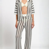 Person wearing a black and white matching set on a white background.