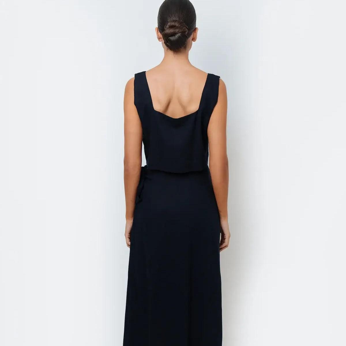 Women wearing a matching navy top and maxi skirt.