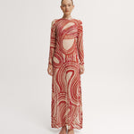 Model wearing a red and white patterned dress on a white background.