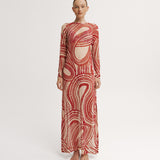 Model wearing a red and white patterned dress on a white background.