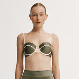 Woman wearing a green bikini with white accents.