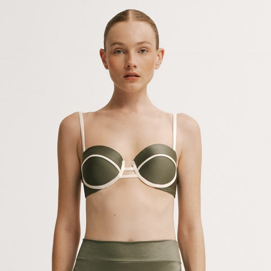 Woman wearing a green bikini with white accents.