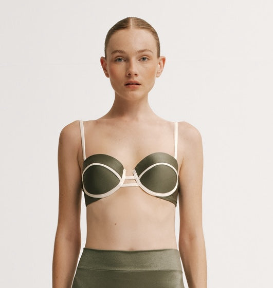 Woman wearing a green bikini with white accents.