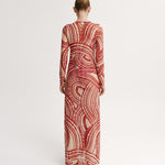 Woman wearing a red and white patterned dress on a white background.