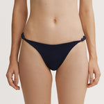 Navy blue bikini bottom on a plain background.
