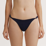 Navy blue bikini bottom on a plain background.