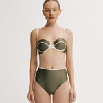 Woman wearing a green bikini with white accents.