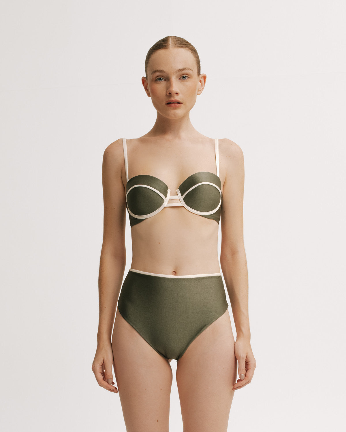 Woman wearing a green bikini with white accents.