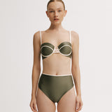 Woman wearing a green bikini with white accents.