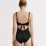 Black swimsuit with open back design on a white background