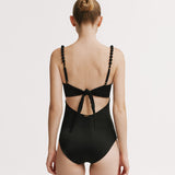 Black swimsuit with open back design on a white background