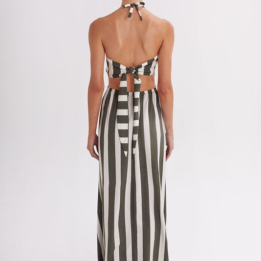 Back of woman wearing a green and white striped dress on a white background
