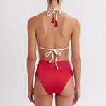 Red bikini with white straps on a plain background