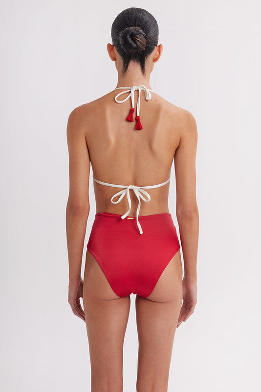 Red bikini with white straps on a plain background