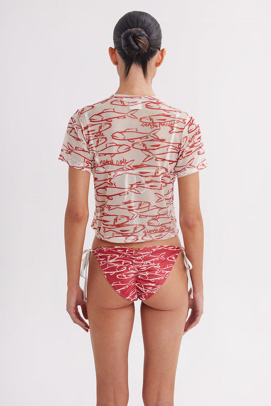 Person wearing a red and white patterned outfit on a plain background