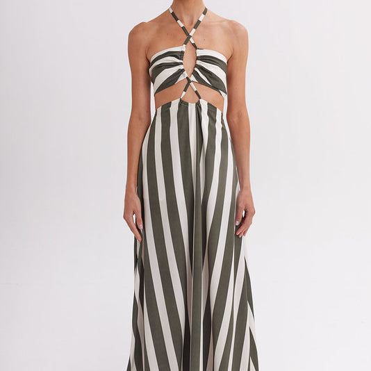 Woman wearing a green and white striped tied dress on a white background