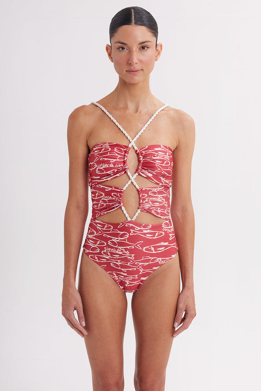 Woman wearing a red and white patterned swimsuit on a white background