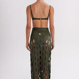 Person wearing a green cut-out skirt on a white background