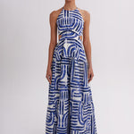 Woman wearing a blue and white patterned dress on a white background